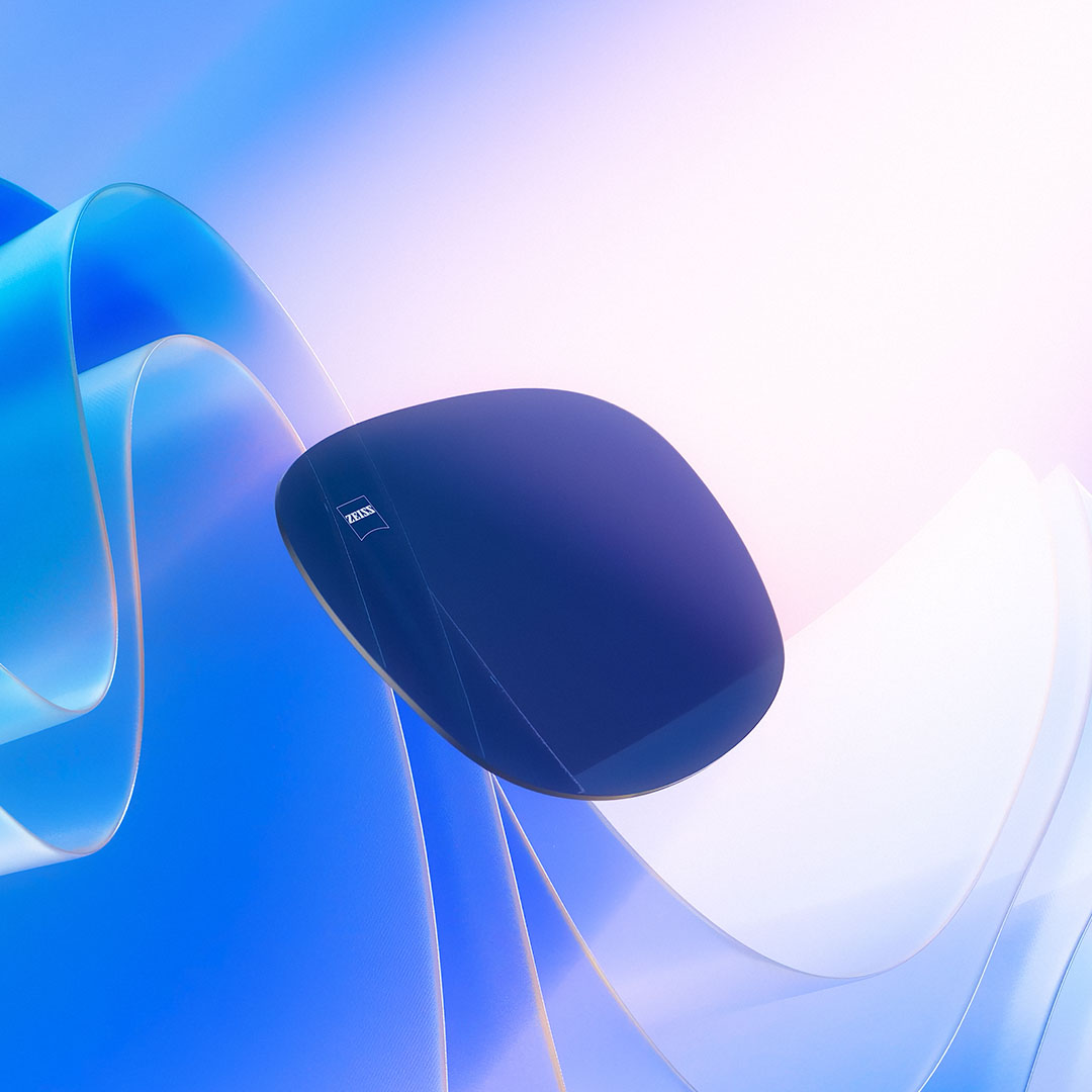 Wygenerowana komputerowo wizualizacja barwionej soczewki skierowanej w stronę światła słonecznego, ilustrująca jej zdolność blokowania promieni UV.